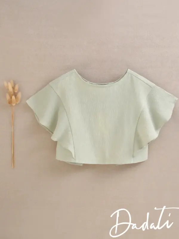 blusa niña verde espalda abierta y volante en manga