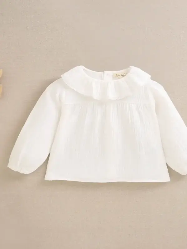 Blusa de bebé niña de muselina color blanco con volante en el cuello