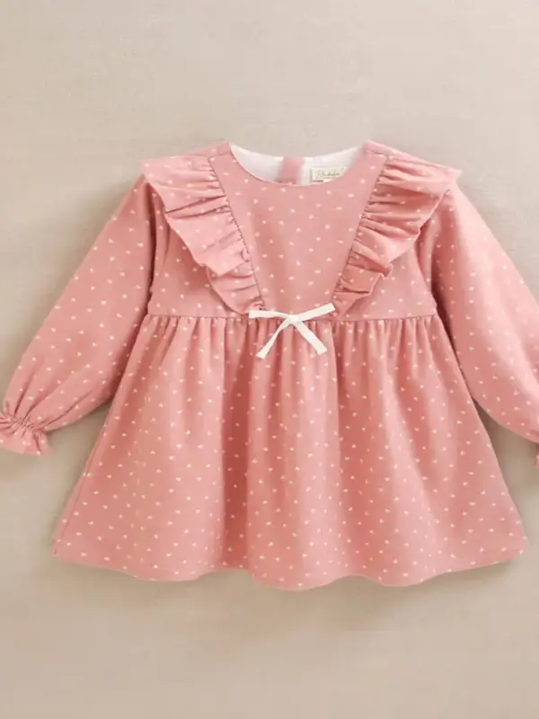 Vestido de niña rosa con estampado y detalle de lazo